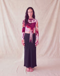Bloom Top in rose print with bell sleeves and a front tie, worn with a black maxi skirt