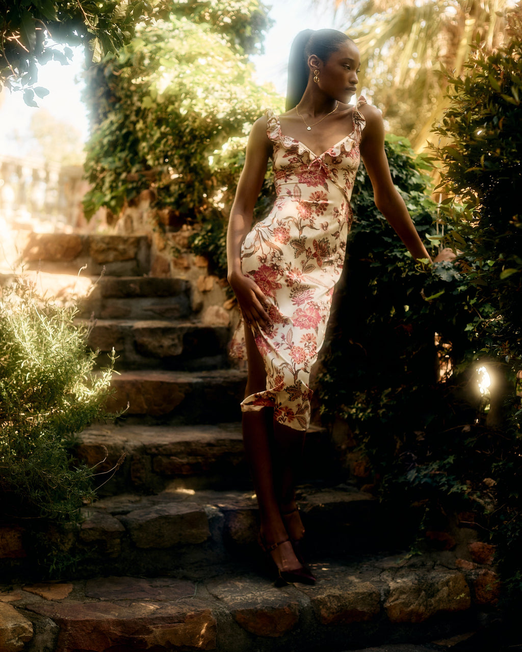 Florence Dress in the red and pink floral print, walking down garden steps