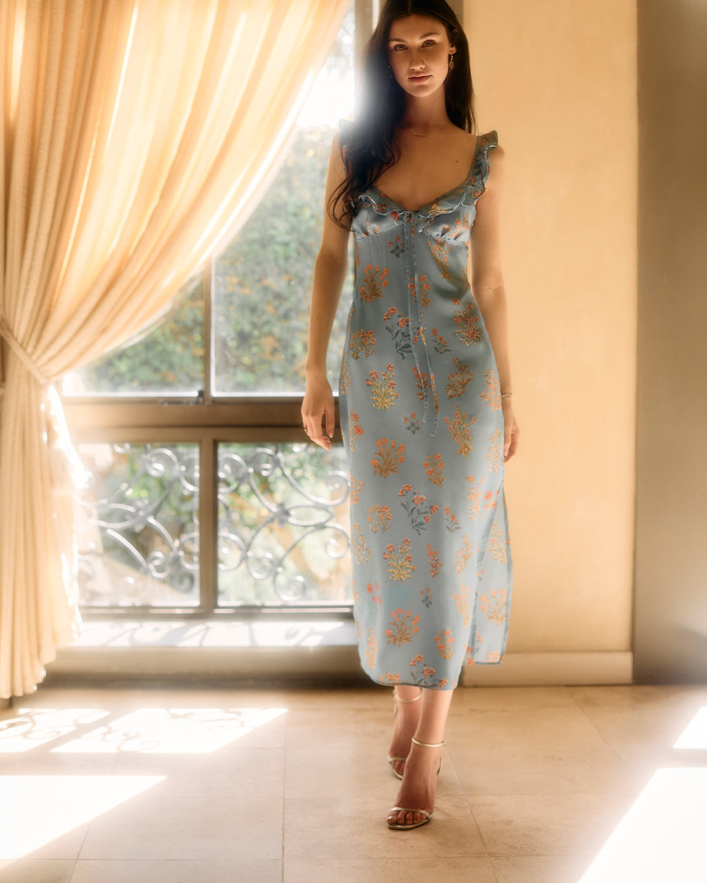 Florence Dress Silk in the blue floral print, walking toward the camera