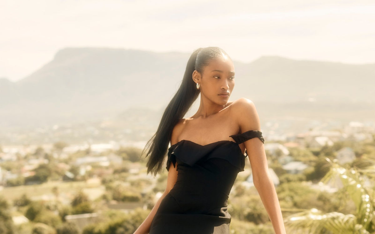 Rosalia Dress in black on a terrace with Table Mountain behind