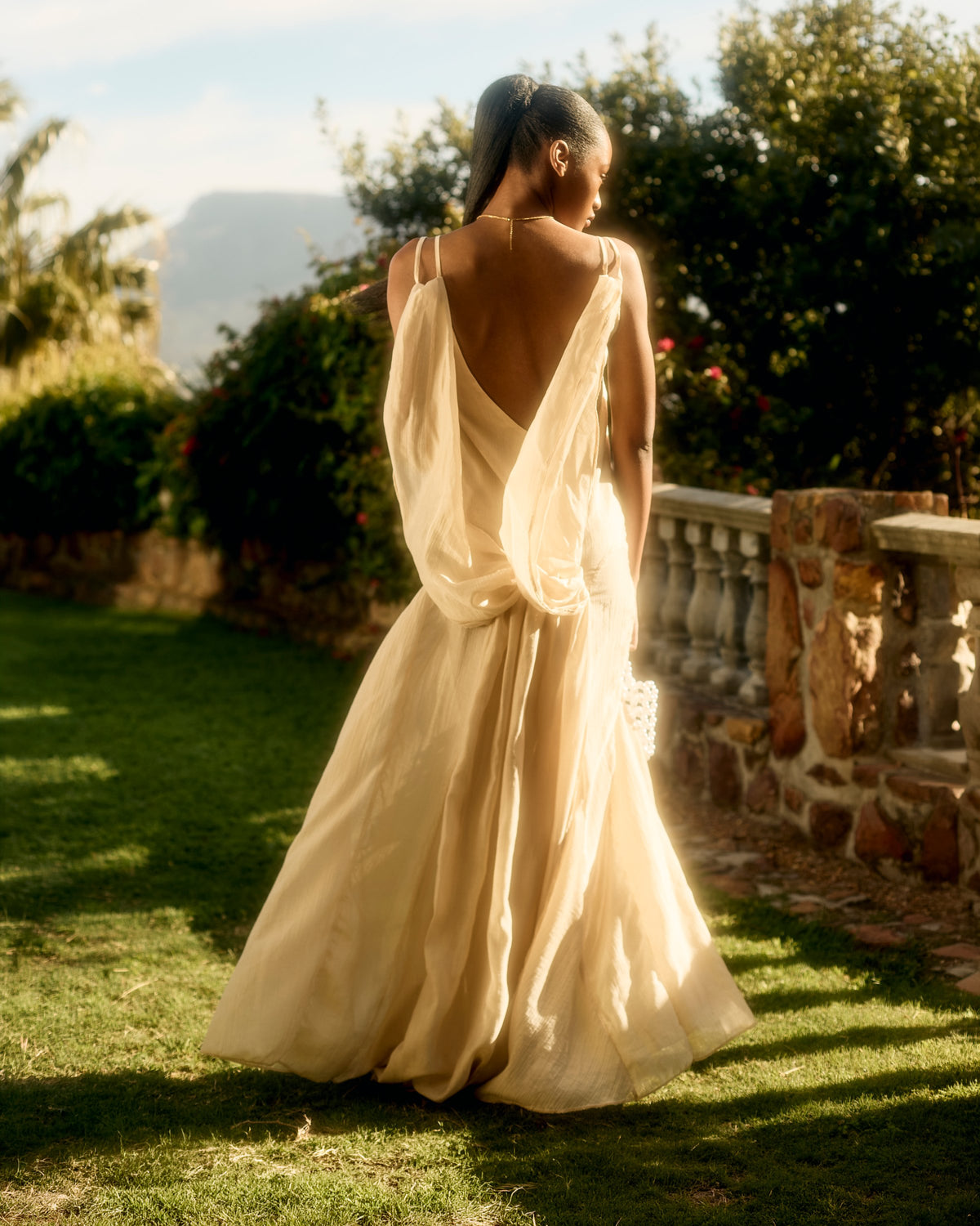 Draped open back of the Sienna Dress in pearl