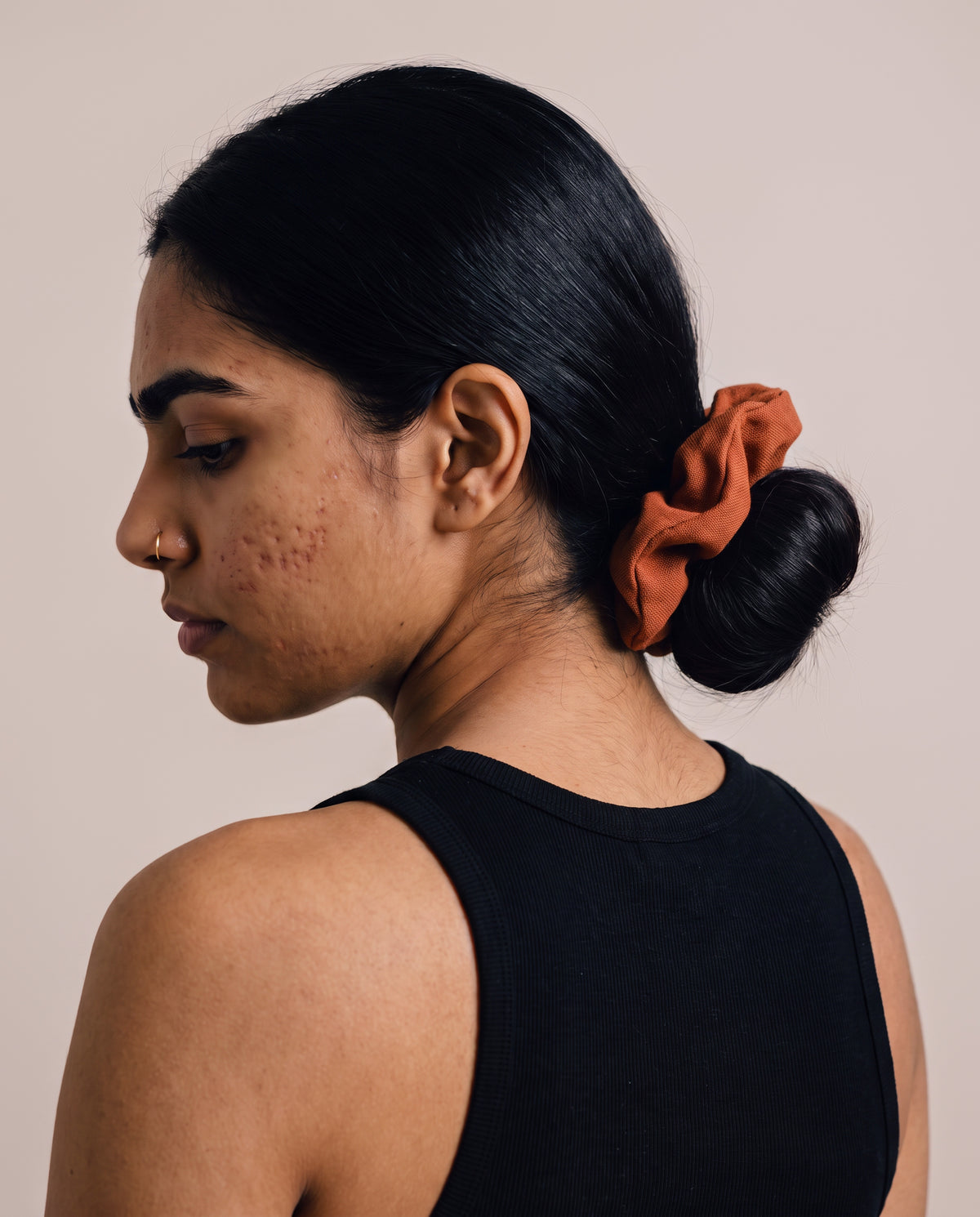 Linen Scrunchies in Copper, worn in a low bun